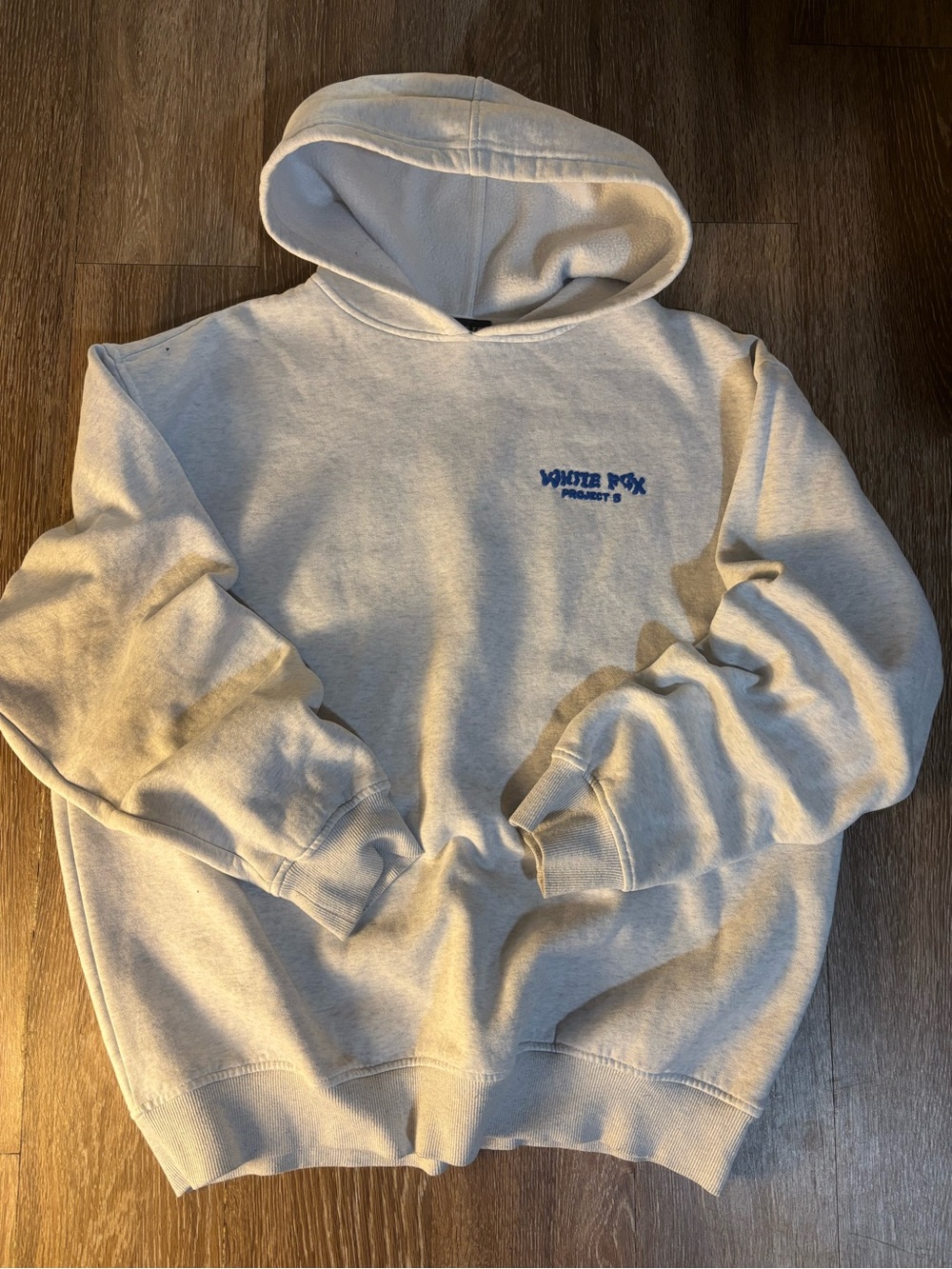 Women’s White Fox Hoodie. Gray hoodie with blue puffy text